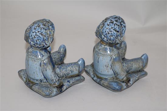 A pair of Clarice Cliff golly blue mottle glazed bookends, height 15.5cm, one damaged